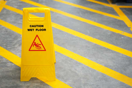 Warning sign for wet floor in the factory officeの写真素材