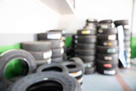 Blurred abstract background of car in garage for change tire, automotive and maintenance conceptの写真素材