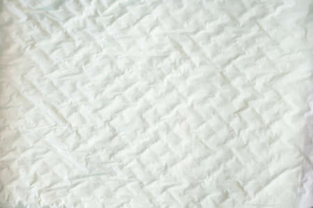 closeup white and soft baby cloth crumpled diapers or disposable flat bed sheet with square...
