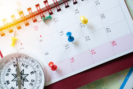 close up of calendar and compass on the map background, planning for business meeting or travel planning conceptの写真素材