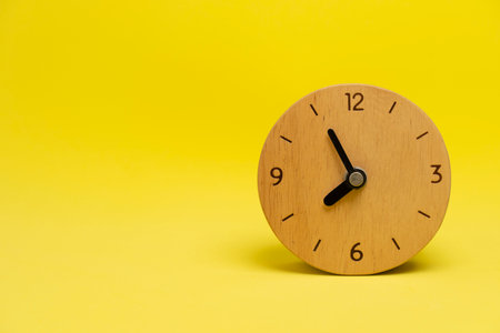 Retro alarm clock on yellow table background, vintage style, flat layの写真素材