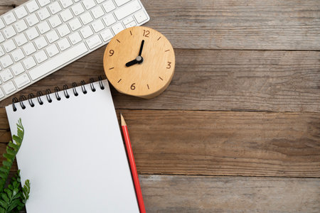 close up of workspace desk with notebook and computer keyboard with copy space wooden table background, minimal style, for creative flat lay conceptの写真素材