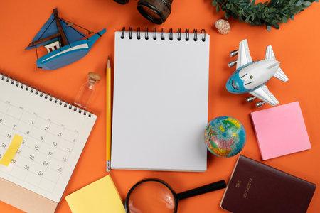 Flat lay concept of travel accessories vacation trip and long summer weekend planning on orange color table with blank space for text background.の写真素材
