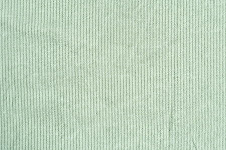 Clothing fabric green texture background, close up of cloth textile surface abstract.