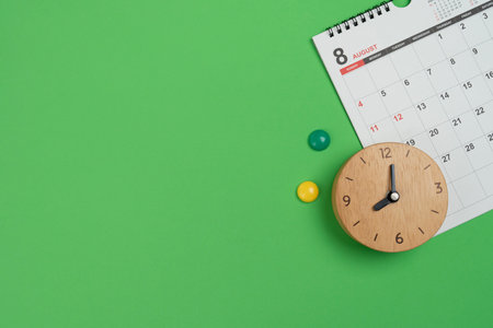 close up of calendar and clock on the green table background, planning for business meeting or...