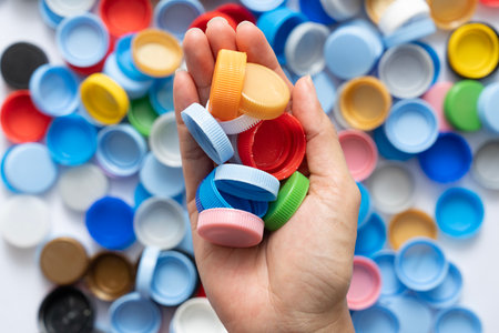 woman hand holding plastic bottles caps for recycling to conserve the environment, Recycling, reuse, garbage disposal, save the world concept.の写真素材