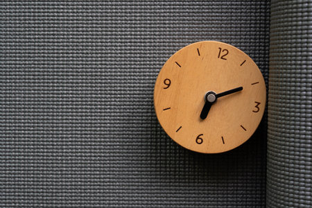 Close up gray yoga mat and clock texture and background, sport concept.の写真素材