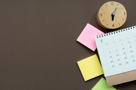 close up of calendar on  clock the brown table background, planning for business meeting or travel planning conceptの写真素材