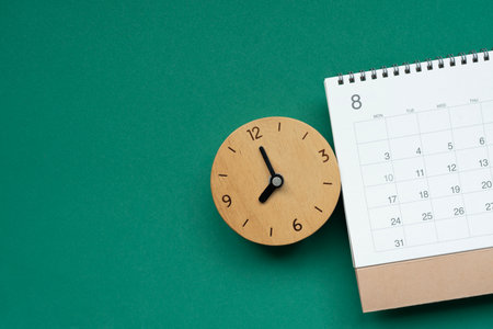 close up of calendar and clock on the green table background, planning for business meeting or...