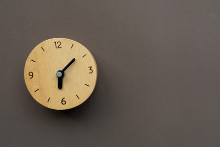 Retro alarm clock on brown table background, vintage style, flat layの写真素材