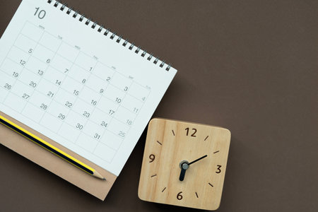 close up of calendar and clock on the brown table background, planning for business meeting or...