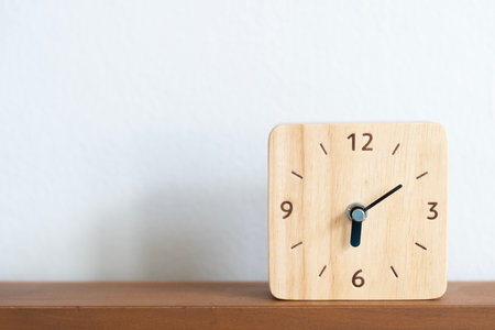 Retro alarm clock on the bed background, vintage style, flat lay