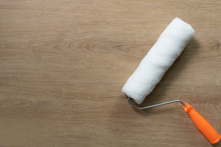 close up brush painting roller white on the wooden table, diy and repair house conceptの写真素材