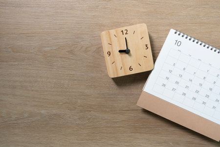 close up of calendar on the wooden table background, planning for business meeting or travel...