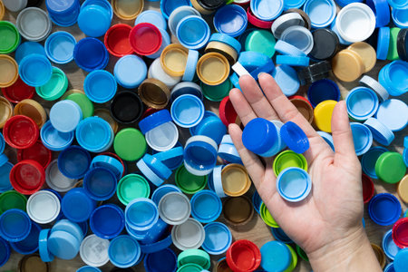 Close up hand holding plastic bottles cap for recycling to conserve the environment, recycling,...