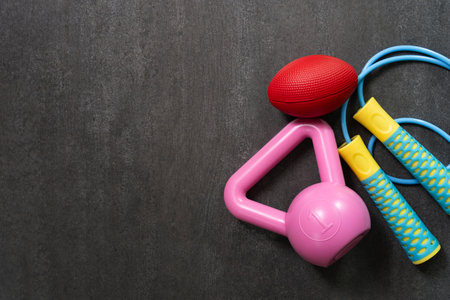 Time for exercising sport equipment on the black table background, healthy and workout conceptの写真素材