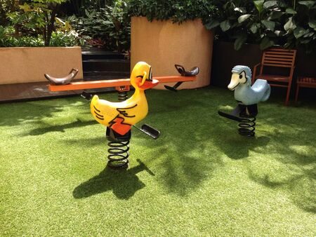 Playground located in the small garden on a sunny dayの素材