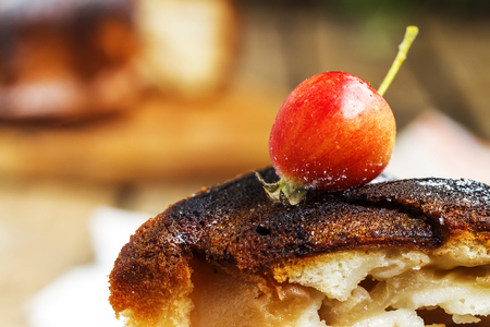 Apple on the pie of charlotte on the old wooden background for Christmas. Close up viewの写真素材
