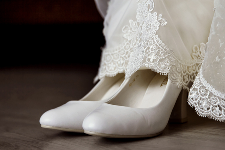 Beautiful white fashion wedding shoes and dressの写真素材