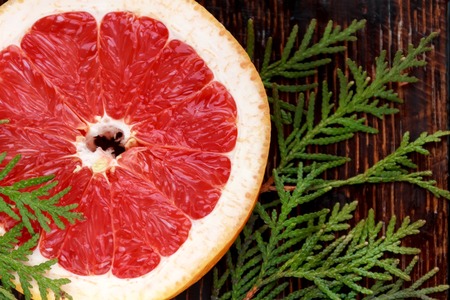 A Slice of Grapefruit on a Pink Background
