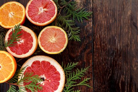ripe fresh sliced grapefruit and orange on wooden backgroundの写真素材