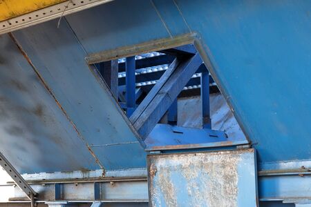 Element of old abandoned grain drying complex. Old building for storing and pouring grain.