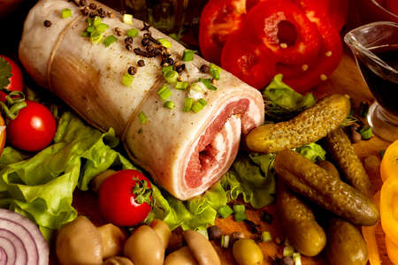 Delicious homemade lard spread with vegetables, bread and spapes on wooden table, flat lay. Cooking meat at homeの写真素材