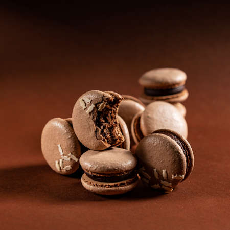 Some beautiful brown macarons cakes against a monochromatic brown background.の写真素材