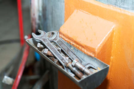 Old tools for mens work. Hammer and wrenches. Hang neatly in the box. Working old tools for repairing devices at the enterpriseの写真素材