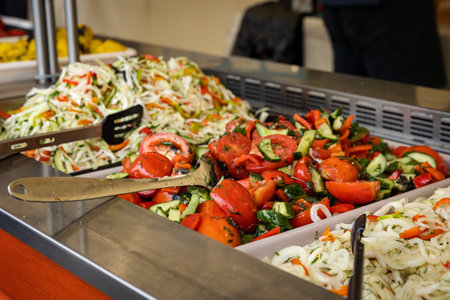 Streetfood buffet with a variety of salads and vegetablesの写真素材