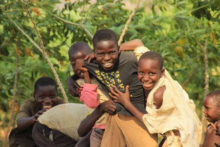 Kampala, Uganda - January 27, 2015: African village children play near their homes in the Kampala suburb.のeditorial素材