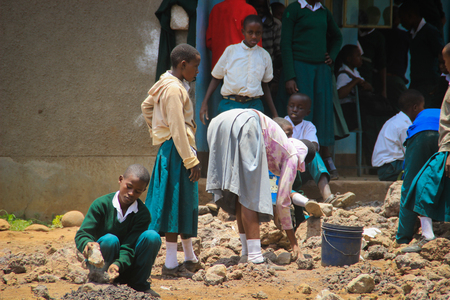 Arusha, Tanzania - March 13, 2015: Tanzanian public high school students work in the school yardのeditorial素材
