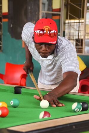 Livingstone, Zambia - March 3, 2015: Zambian black guys play billiards