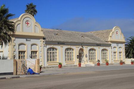 Swakopmund, Namibia - April 18, 2015: Old-time German buildings and architecture: a hotel in a former hospital building and an African city roadのeditorial素材
