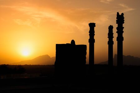 The famous ancient city of Persepolis in Iran (Persia) at sunset. Silhouettes of columns at sunsetの写真素材