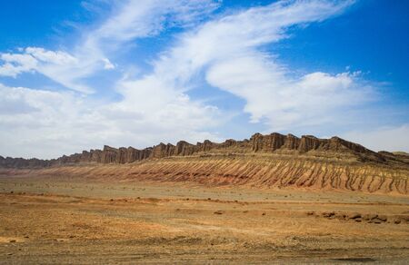 Desert landscape with rocks and geological formations on a hot summer day on the road from Kerman to Mashhad. Desert of Iran.の写真素材