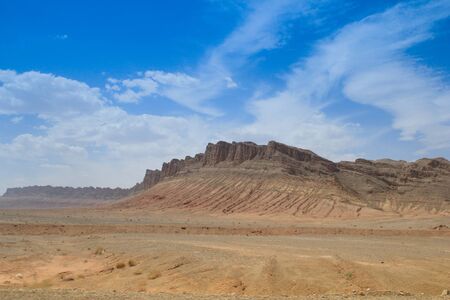 Desert landscape with rocks and geological formations on a hot summer day on the road from Kerman to Mashhad. Desert of Iran.の写真素材