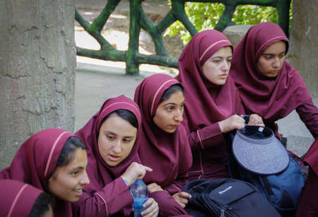 Shiraz, Iran - May 10, 2017: a large group of schools are relaxing in nature. Teenage girls from an Iranian school in school uniforms and hijabs.のeditorial素材