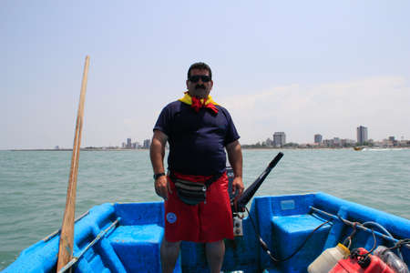 Caspian Sea, Iran - May 25, 2017: A male captain of a small boat prepares to carry tourists by sea.のeditorial素材