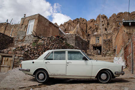 Tabriz, Kandovan, Iran - May 5, 2017: White car on the background of the stone fence of the village of Kandovan. Tabriz, Iranのeditorial素材