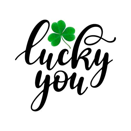 Lucky you - black handwritten lettering with realistic three-leaf shamrock isolated on white background. 17 March St. Patrick's Day design. Good for posters, greeting cards, t-shirt, and mug design.のイラスト素材