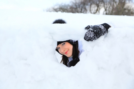 Laughing beautiful girl portrait in winter time with snow.の写真素材