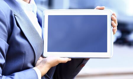 Close-up of businesswoman working with touchpad outdoor