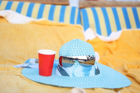 Summer blue hat and glasses on the loungeの写真素材