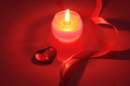 Valentine candle on red backgroundの写真素材