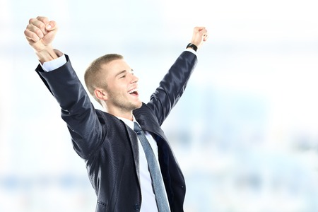 Successful businessman celebrating - isolated over a white backgroundの写真素材