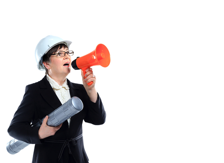 Mature woman carrying building plans and shout in megaphone - isolated on whiteの写真素材