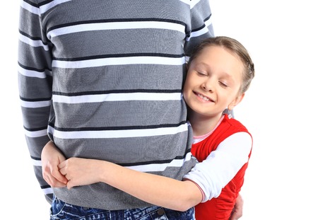 Girl hugging her father - isolated over a white backgroundの写真素材