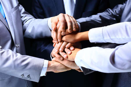 Business group with hands together - teamwork concepts