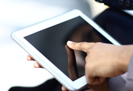Close-up of female hands touching digital tablet
